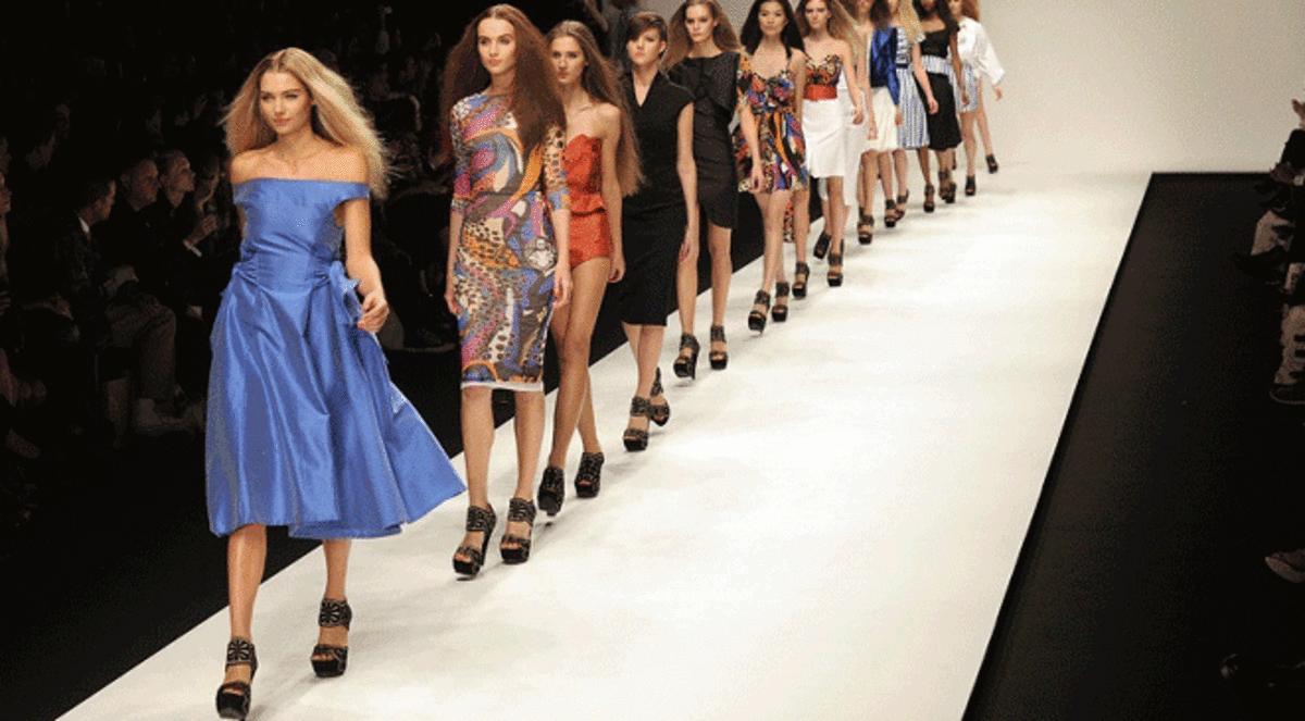 Fashion models walking runway together
