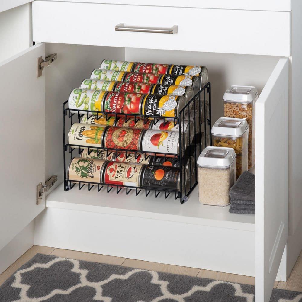 Rolling metal can rack organizes canned vegetables and soups inside a lower kitchen cabinet.