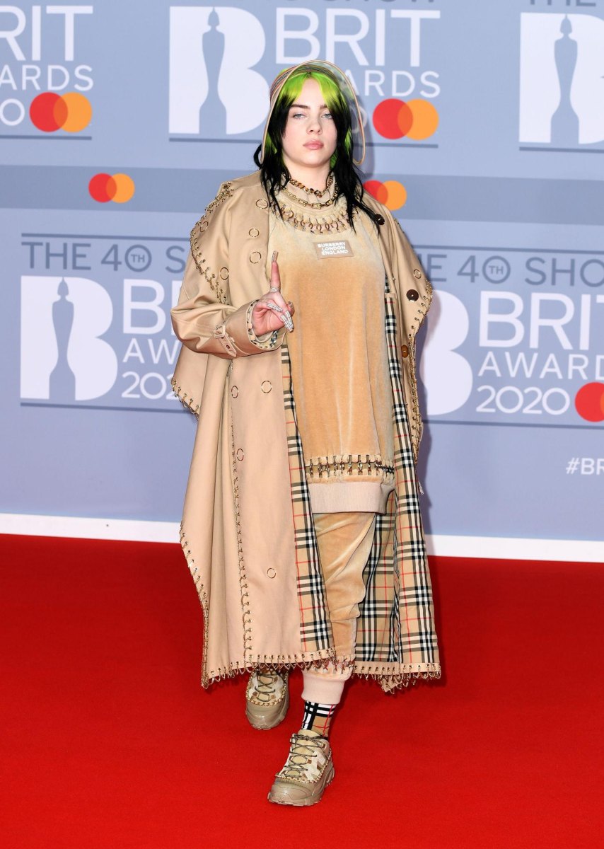 Billie Eilish standing at a public event