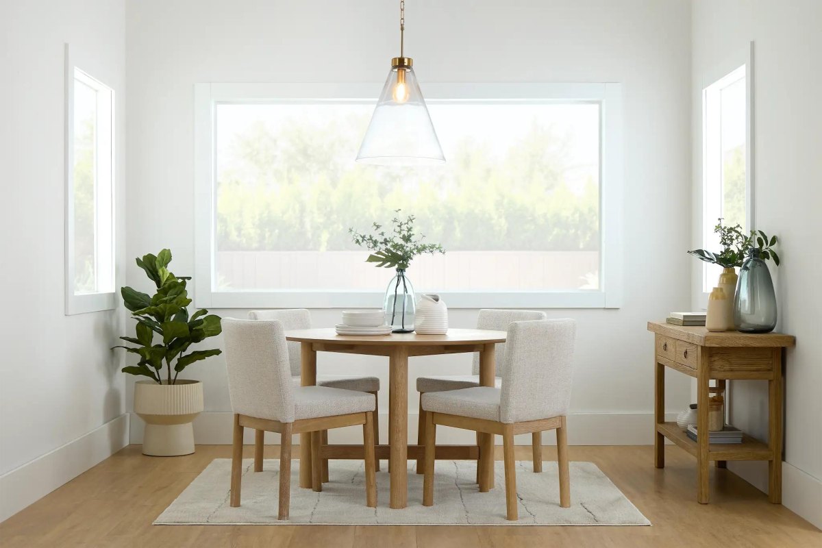 Inviting dining area with oak table upholstered chairs and pendant light