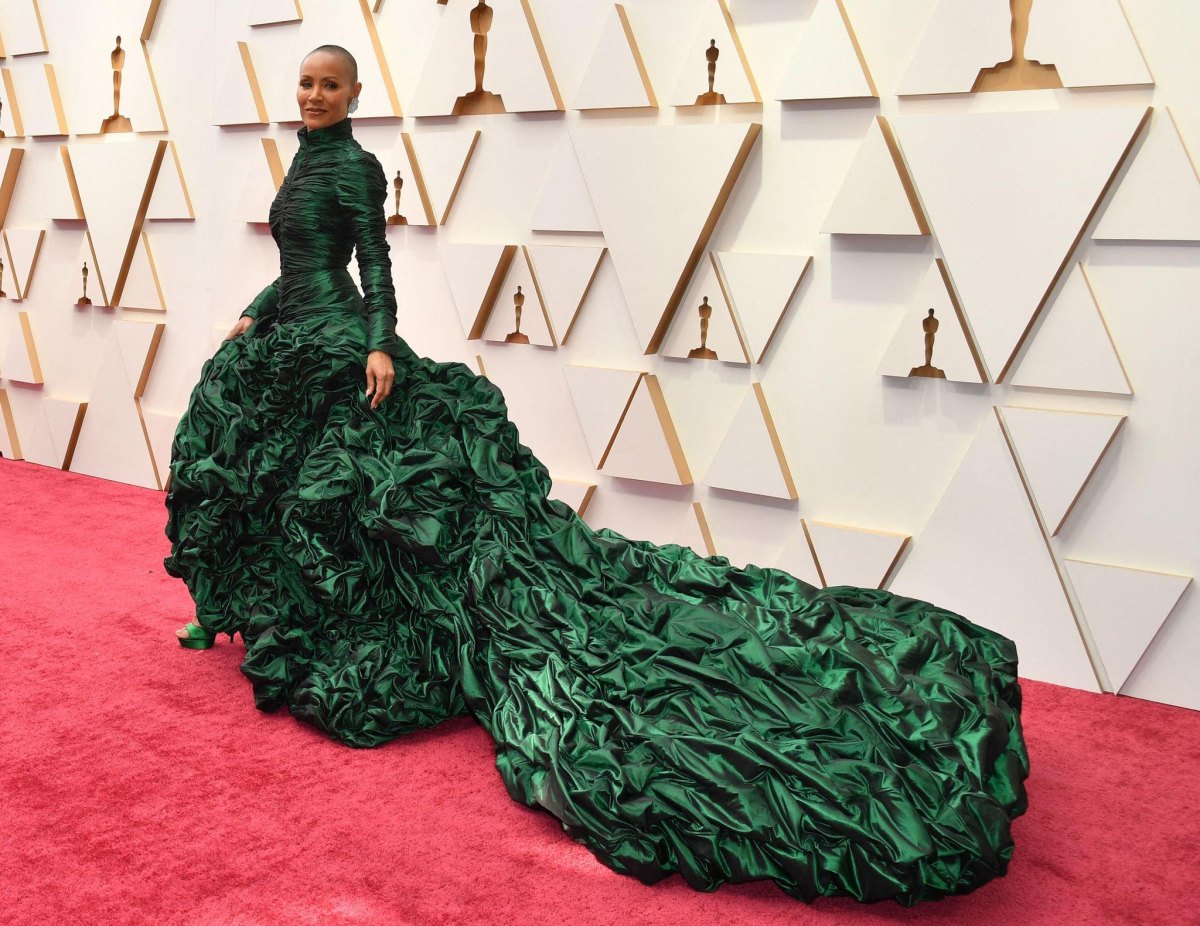 Red couture evening gown with an elaborate floor-length train