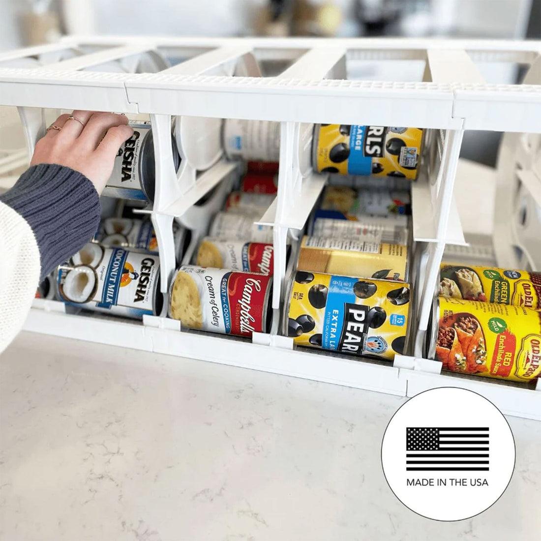 Pull-out pantry can dispenser organizes canned soups, beans, and other staples inside a cabinet.