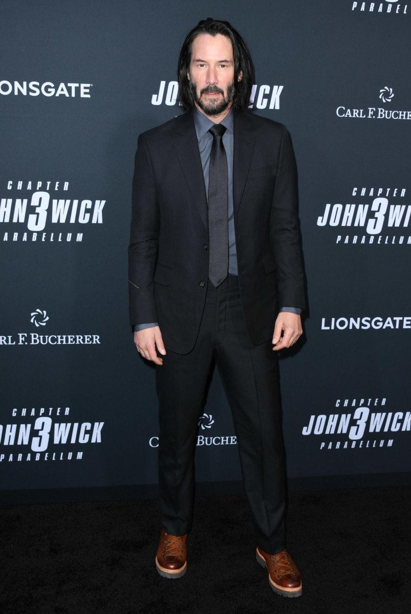 Keanu Reeves standing at a film event