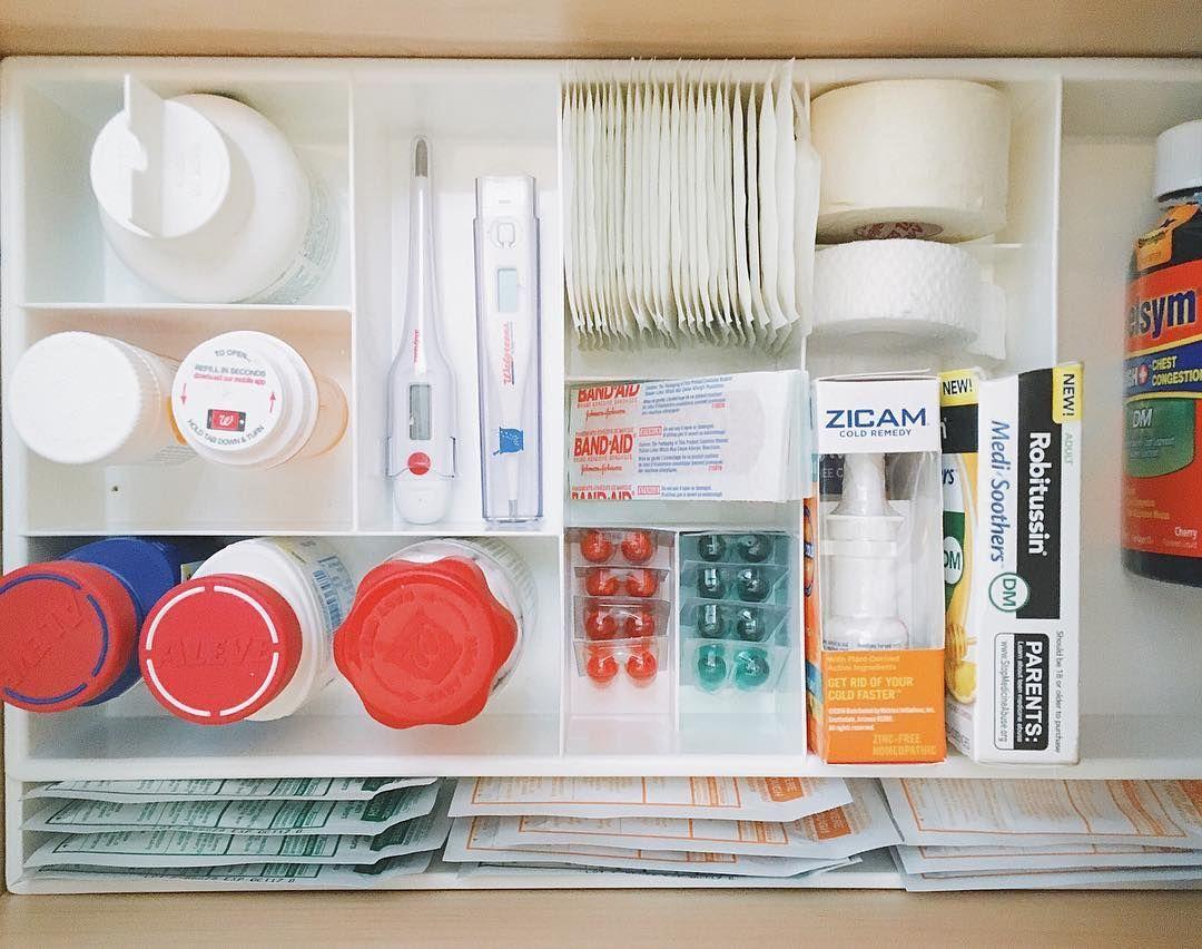 Bathroom drawer with bandages thermometer and personal care supplies in separate bins