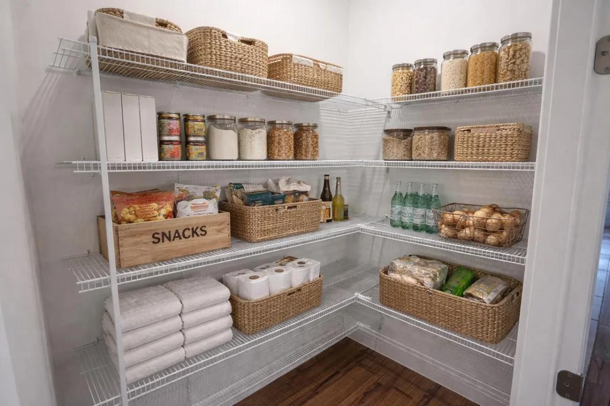 Open baskets neatly organizing snacks in a walk-in pantry
