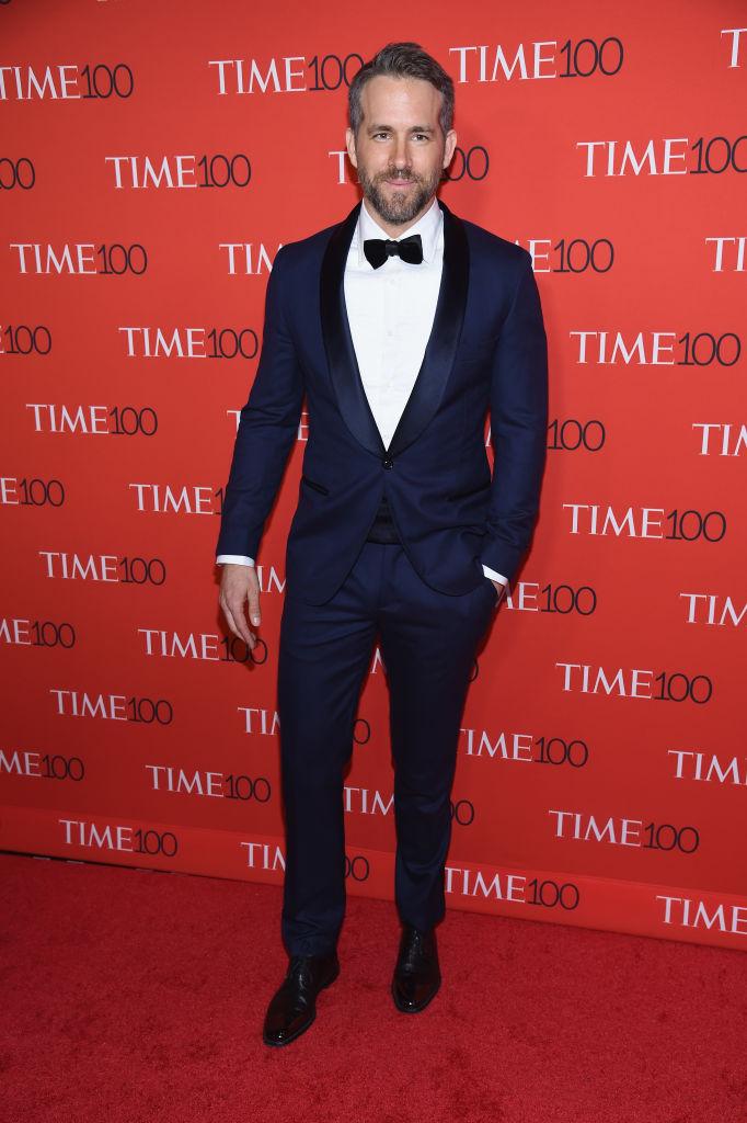 Ryan Reynolds standing at a public event