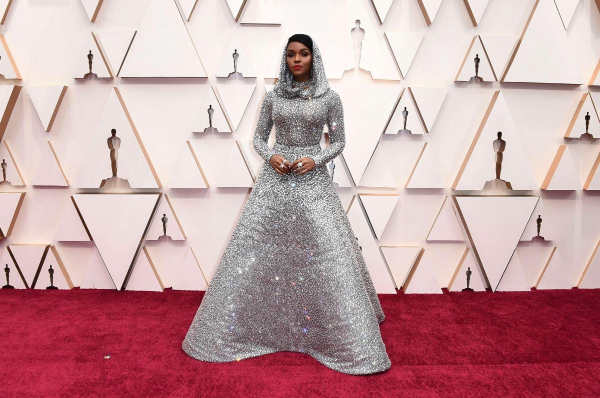 Silver crystal-embellished evening gown sparkling under red-carpet lights