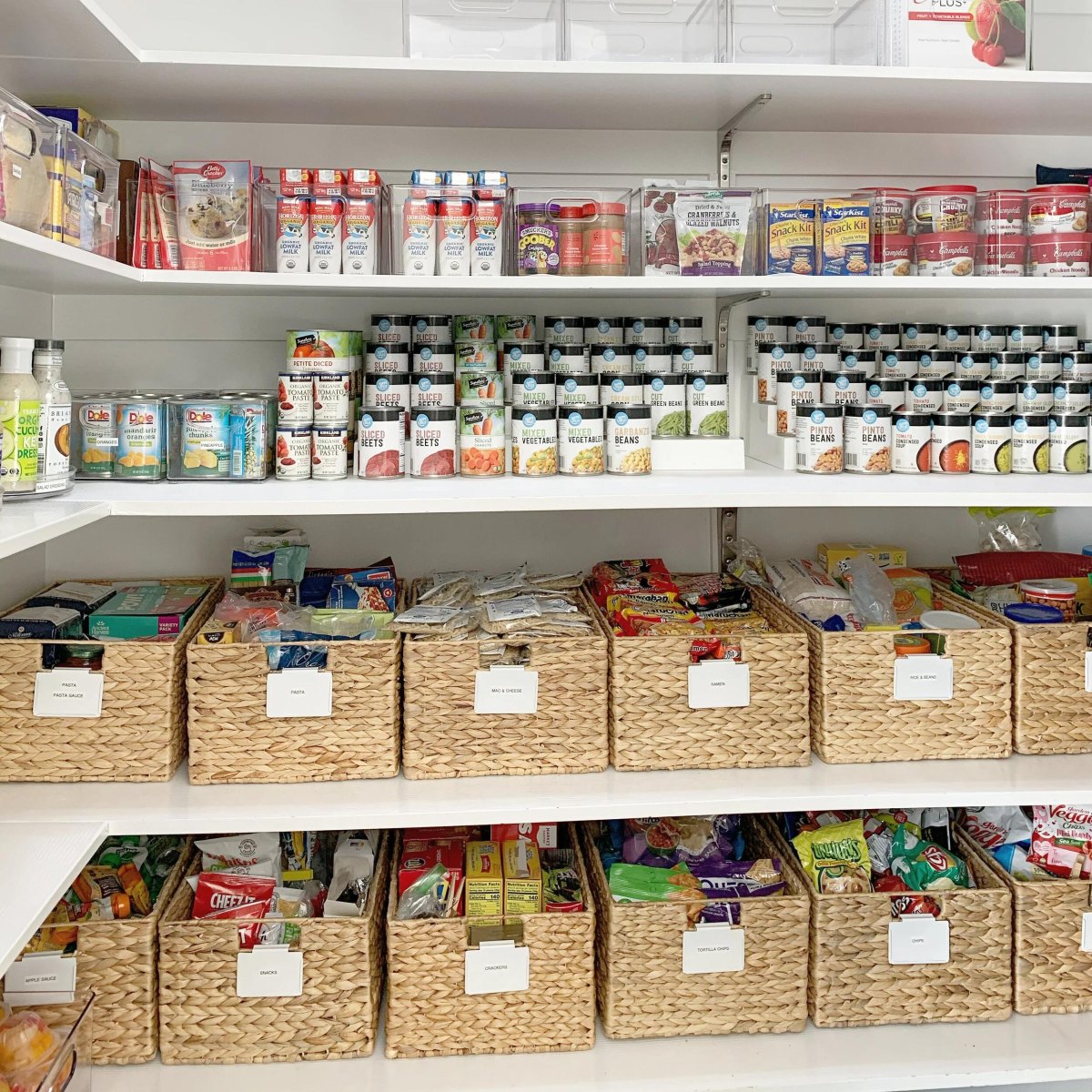 Family pantry shelves combine organized canned goods with labeled baskets for snacks and dry foods.