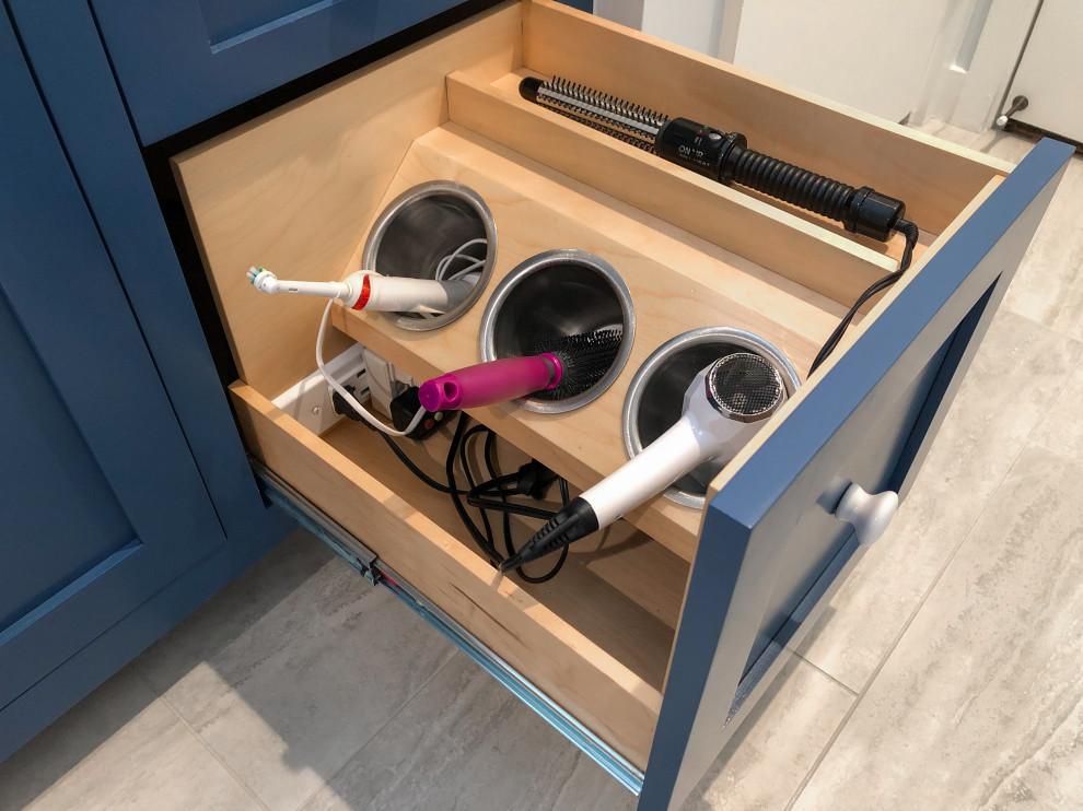Bathroom drawer with hair dryer curling iron and straightener stored separately