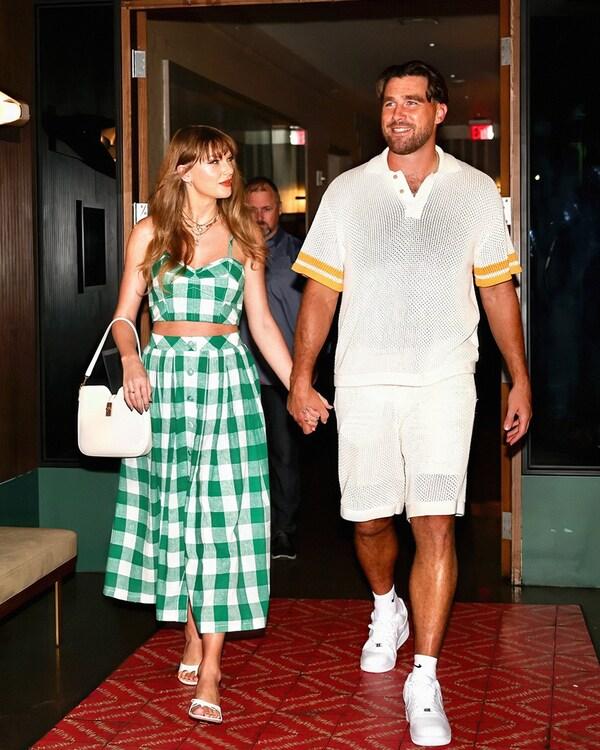 Taylor Swift and Travis Kelce standing together