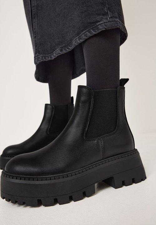 Raised sole boots adding height